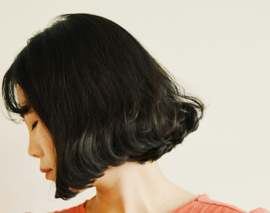 woman with short brown bob looking to the side