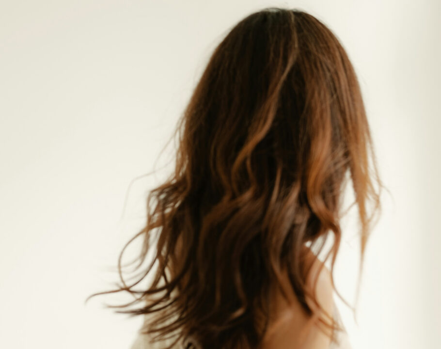 back view of woman with brown wavy hair