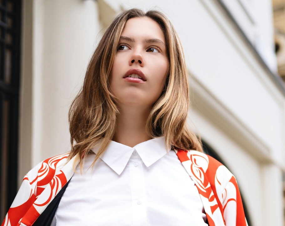 blonde woman in white blouse and red and white jacket