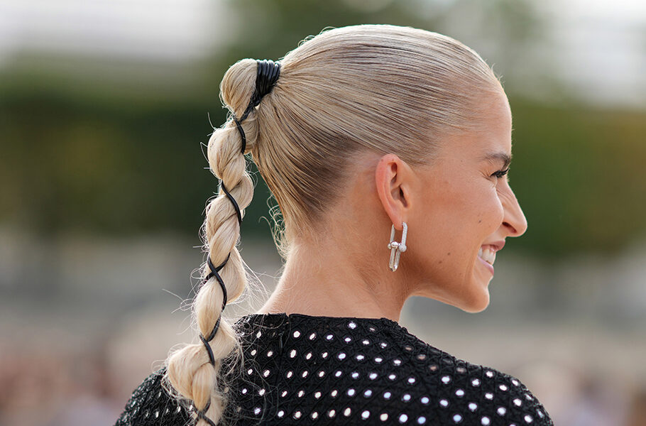 Caroline Daur wears earrings, a black and silver bejeweled shiny mini / short dress, bracelets, a pink bag outside Dior, during the Womenswear Spring/Summer 2024 as part of Paris Fashion Week on September 26, 2023 in Paris, France.
